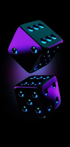 two black and purple dices with blue lights on them