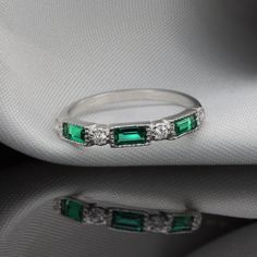 "Handmade by an inspired jewelry artist team with decades of experience in the craft of jewelry making. Each gemstone, each diamond is carefully picked. Using only the finest raw materials and the highest industry standard in manufacturing, design and finish. Perfect Baguette Emerald and round diamonds stacking ring in a vintage milgrain setting Ideal for stacking with your other rings, Adds to every stack but doesn't steal the show. Rounded inner edges for comfort, You will never want to take i Green Baguette Cut Fine Jewelry, Antique Round Multi-stone Emerald Ring, Green Multi-stone Baguette-cut Jewelry, Green Baguette Cut Multi-stone Jewelry, Art Deco Multi-stone Emerald Ring Gift, Diamond Stacking Rings, White Gold Wedding Bands, White Gold Wedding, Eternity Wedding Band