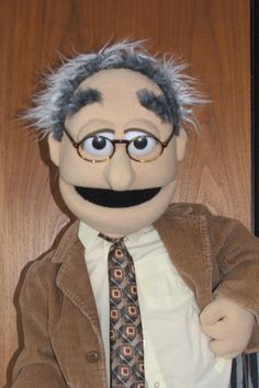 the puppet is wearing glasses and a tie