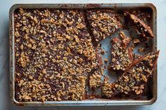 a baking pan filled with brownies and nuts