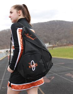 a girl with a backpack walking down the road