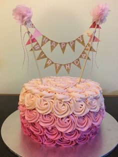 a birthday cake decorated with pink and purple frosting