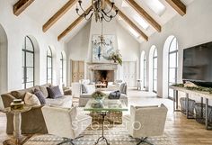 a living room filled with furniture and a flat screen tv mounted on a wall next to a fire place