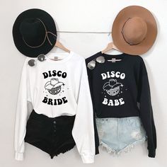 These Disco Bride and Disco Babe shirts are perfect for a night out in Nashville! These Last Disco Bachelorette Party Shirts give a cute retro vibe. Featuring a cute disco cowgirl design, this tee is perfect for any bach party weekend! This unisex heavy blend crewneck sweatshirt is pure comfort. These garments are made from polyester and cotton. This combination helps designs come out looking fresh and beautiful. The collar is ribbed knit, so it retains its shape even after washing. There are no Disco Cowgirl Bachelorette Shirts, Disco Style White Top With Graphic Print, Bachelorette Party Disco, Cowgirl Bachelorette Shirts, Last Disco Bachelorette Party, Disco Bride, Last Disco Bachelorette, Disco Bachelorette Party, Cowgirl Disco