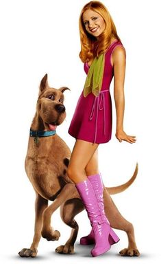 a woman standing next to a dog wearing pink boots