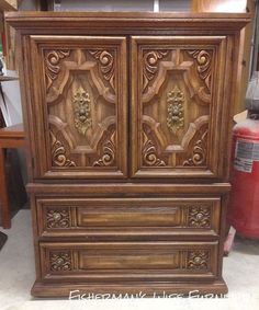 an old wooden armoire with carvings on it