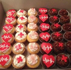 a box filled with lots of cupcakes covered in red and white frosting