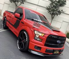 a red truck parked in front of a building