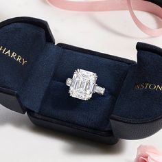 an engagement ring in a velvet box with the name harry written on it and pink flowers