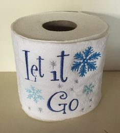 a roll of toilet paper with let it go written on the side and snowflakes