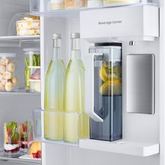 the refrigerator door is open and there are several bottles in it, including lemonade