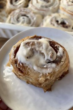 a cinnamon roll sitting on top of a white plate