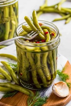 pickled green beans in a jar with a spoon