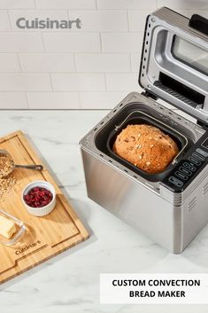 a loaf of bread sitting inside of a toaster oven next to a cutting board