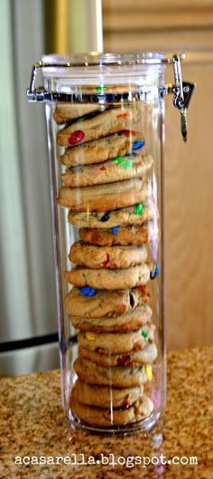 a glass jar filled with cookies on top of a counter