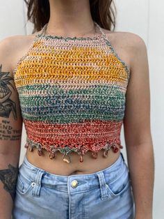 a close up of a person wearing shorts and a top with crochet on it