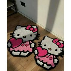 two hello kitty rugs sitting on the floor