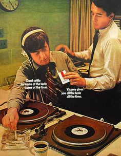 an advertisement for the record player's turntables, with two men looking at them