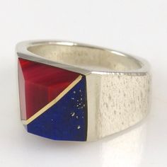 Sterling Silver Ring with Channel Inlaid Rosarita and Lapis. This ring also features 14k gold spacers. Ring Size: 6.25 Band Width: .125" - .5" .375" Setting Width, .375" Setting Height Lapis Ring, Sterling Silver Ring, Cuff Bracelets, Silver Ring, Sterling Silver Rings, Ring Size, Silver Rings, Cuff, Size 6