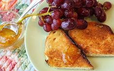 two slices of french toast with grapes on the side