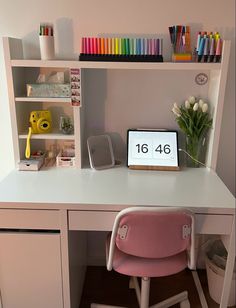 a white desk topped with a pink chair next to a shelf filled with markers and pencils