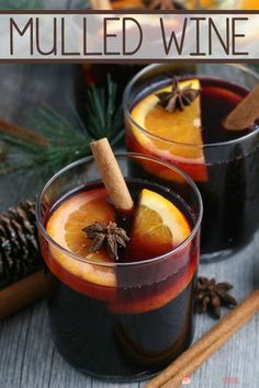 two glasses filled with mulled wine and cinnamon sticks