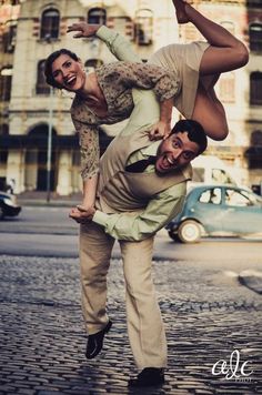 two men doing acrobatic tricks on the street