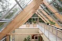 the inside of a building with lots of windows and plants growing in pots on the roof