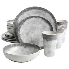 an assortment of gray and white dinnerware