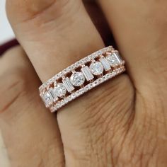 a woman's hand with a diamond ring on her left and an engagement band on her right