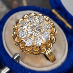 This bold Victorian style cluster vintage diamond cocktail ring contains nine (9), prong/bead set, old mine cut diamonds. The ring measures 17.0mm at the top, rises 10.0mm above the finger, tapering to 1.3mm wide and 1.2mm thick at the base of the shank. The ring is currently size 6.5. Victorian Diamond Cluster Ring, Victorian Diamond Cluster Ring With Diamond Cut, Victorian Cluster Ring With Diamond Cut, Vintage Cluster Ring With Rose Cut Diamonds, Vintage Style Diamond Cluster Ring With Rose Cut, Victorian Style Diamond Cluster Ring, Vintage Rose Cut Diamond Cluster Ring, Antique Diamond Ring With Rose Cut For Vintage Events, Antique Diamond White Cluster Ring