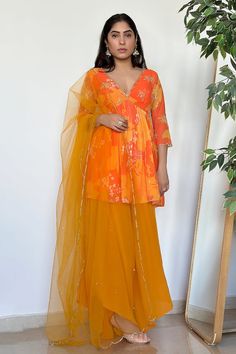 Yellow, orange padded peplum kurta with floral print and scallop V neckline. Paired with flared pant and sequin, cutdana embroidered dupatta. - Aza Fashions Orange Palazzo Set With Gota Work For Festivals, Festive Orange Palazzo Set With Zari Work, Bollywood Style Orange Palazzo Set With Pallu, Orange Palazzo Set With Resham Embroidery, Orange Palazzo Set With Resham Embroidery And Traditional Drape, Orange Palazzo Set With Gota Work For Navratri, Orange Palazzo Set With Zari Work For Festivals, Orange Resham Embroidered Palazzo Set For Festivals, Navratri Orange Palazzo Set With Gota Work