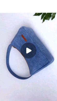 a blue cloth face mask with an arrow on the side and a video playing button