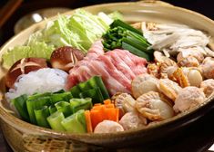 a bowl filled with meat and vegetables on top of a table