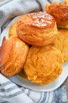 several pastries on a white plate with a blue towel