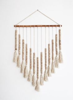 a wind chime hanging on a white wall