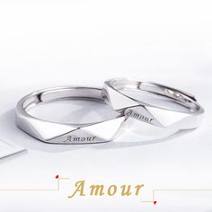 two wedding rings sitting on top of each other with the words amour written below them