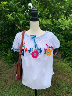 "Hand Embroidered Artisanal Blouse - Mexican Blouse - Fiesta Blouse - S/M This blouse had handcrafted details no other will have. It will fit a size small/medium Measurements: * 23\" long * 27\" wide Care * cloth wipe to clean * delicate care * hang dry Please email me your questions before buying. All of my items come from a smoke and pet free environment. I WILL BE PROCESS YOUR ORDER IN 1 DAY If you need the item expressed shipped please contact me to request it and the listing will be adjuste Artisan Embroidered Summer Top, Artisan Embroidered Tops For Summer, Handmade White Cotton Blouse, Traditional Handmade Multicolor Tops, Traditional Multicolor Handmade Tops, Summer Folk Style Embroidered Top, Peasant Floral Embroidered Top For Beach, Traditional Embroidered Top With Yoke, Handmade Folk Tops For Summer