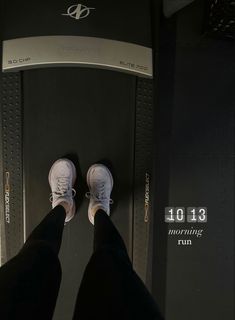 person standing on top of a treadmill with their feet in the air and looking down