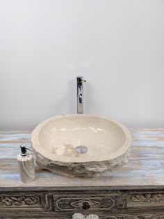 a bathroom sink sitting on top of a wooden counter