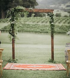 an outdoor ceremony setup with greenery and flowers