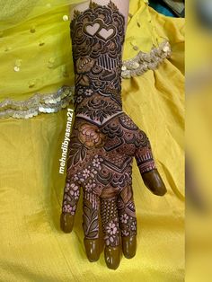 a woman's hand with henna tattoos on it and the words love written in arabic