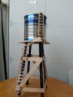 a wooden ladder with a tin can on top