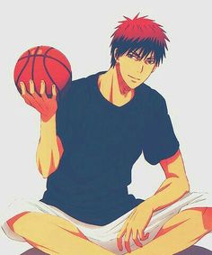 a man sitting on the ground holding a basketball in his hand and wearing red socks