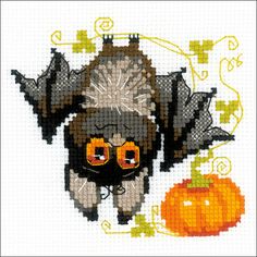 a cross stitch pattern with an image of a bat and a pumpkin on the side