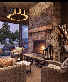 a living room filled with furniture and a fire place in front of a stone fireplace