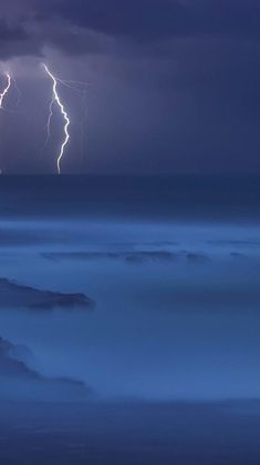 two lightnings are seen above the clouds in this photo taken from an airplane at night