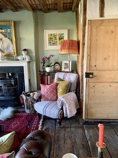 a living room filled with furniture and a fire place next to a door that says extra co