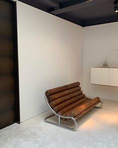 a chair that is sitting in the middle of a room with white walls and flooring