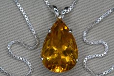 "This citrine necklace is a stunning handmade piece of jewelry that features a natural earth mined citrine pendant set in a solid sterling silver pendant. The necklace length is 18 inches and has a minimalist style, making it perfect for both casual and formal occasions. This necklace is ideal for those with a November birthdate or those who love citrine gemstones. This item is brand new and has been certified by a gemologist at Canadian Federal Gemological Laboratory of Canada. The appraisal will be included with the item and describes the citrine as follows:  \"Shape and cut: Pear Weight: 6.23 ct Species: Natural Quartz Variety: Citrine Colour: Yellow Transparency: Transparent Luster: Vitreous Refractive Index: 1.544 to 1.553 Identifying characteristics: Internal M.S.R.P: $450.00 CAD\" B Pear Shaped Citrine Gemstone Jewelry, Pear-shaped Citrine Gemstone Jewelry, Formal Drop Citrine Jewelry, Formal Teardrop Citrine Jewelry, November Birthstone Jewelry, Citrine Pendant, Citrine Necklace, Gemstone Jewelry Handmade, November Birthstone